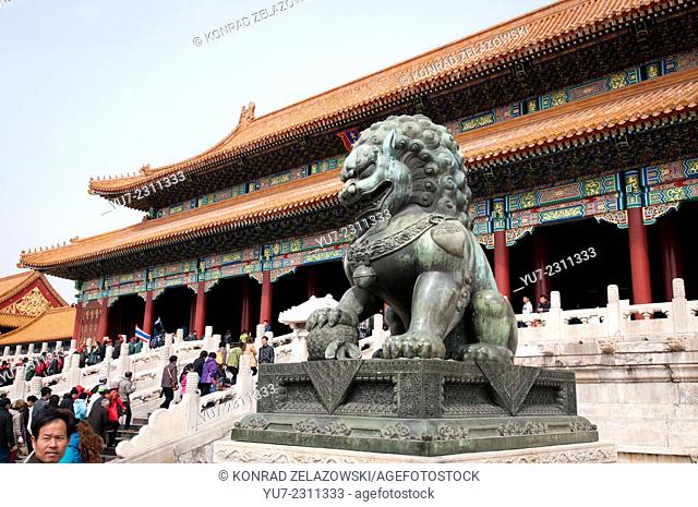 Traditional guardian lion bronze statue in front of Gate of Supreme (Great) Harmony in Forbidden City, Beijing, China