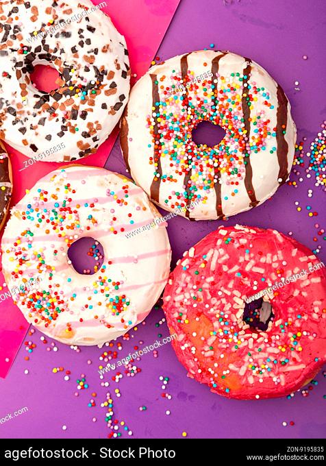 Donuts with icing on color background. Sweet donuts. Donuts background . Eaten donut