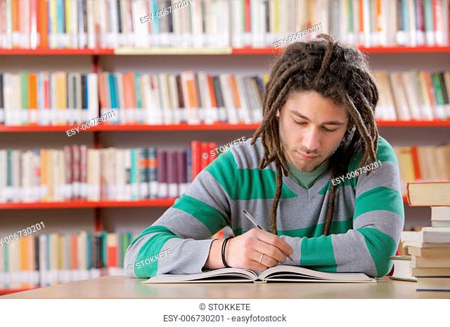 Young male student in the library, studying