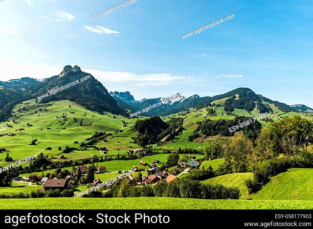 Landscape in Toggenburg with green meadows and pastures near Nesslau, mountains Speer (right) and Mattstock (left) in the background, Canton St