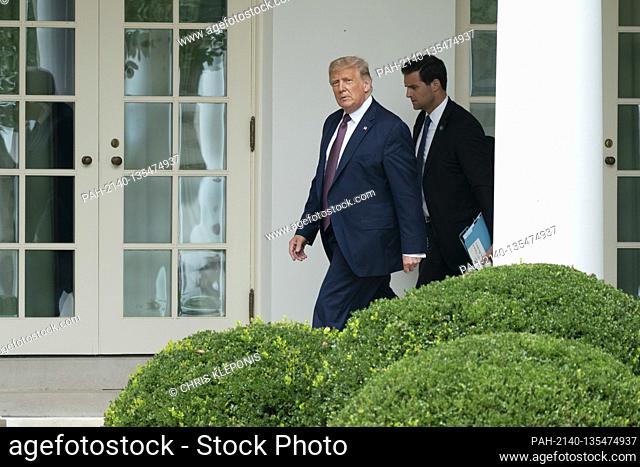 United States President Donald J. Trump walks to the Oval Office with John David McEntee II, Director of the White House Presidential Personnel Office after...