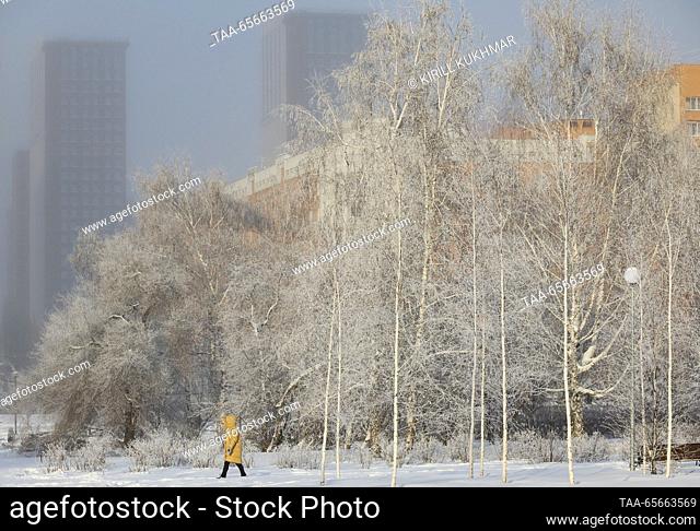 RUSSIA, NOVOSIBIRSK - DECEMBER 12, 2023: A woman is seen in a residential area in Central District during severe frost in winter