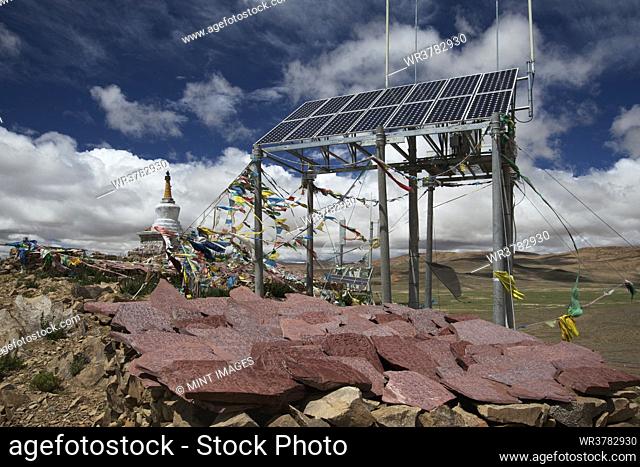 A commercial Solar Cell phone tower, mani stones and prayers flags and a small stupa or Buddhist temple