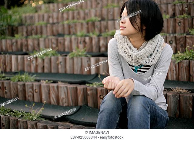Young woman sitting outside