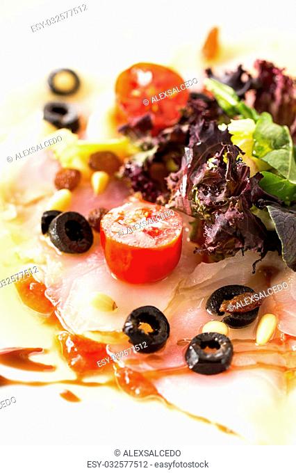Carpaccio cod salad with fresh vegetables and vinegar