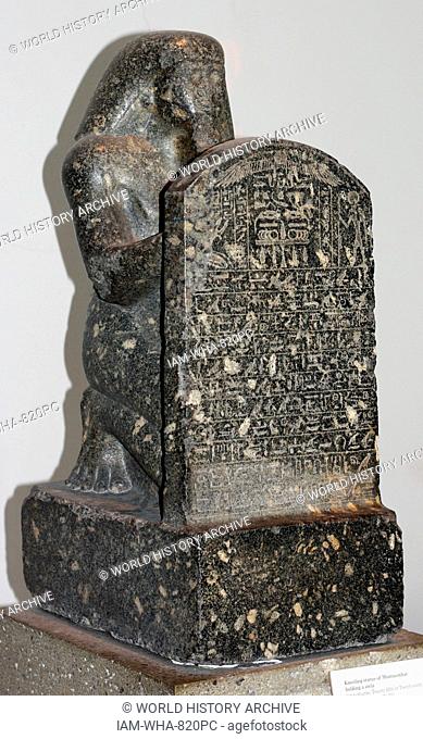Statue of Montuemhat kneeling and holding up a stele. 25th or 26th Dynasty (approx. 670-650 BC) Egyptian. Made from Granodiorite