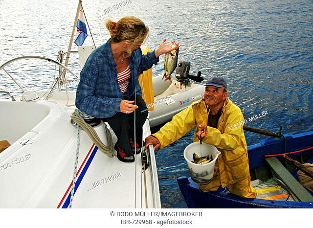 In the bay of Donji Molunat Fisherman Donco brings fresh sea-fish on board, Adria, Croatia