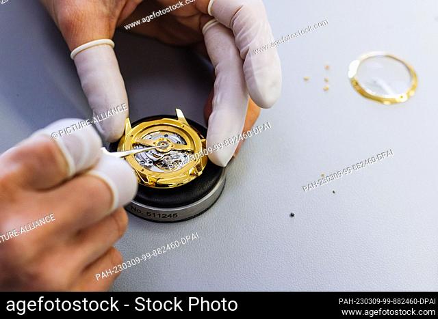 PRODUCTION - 07 March 2023, Baden-Württemberg, Schramberg: A Junghans employee assembles a watch. The watch manufacturer Junghans was founded in 1861 in...
