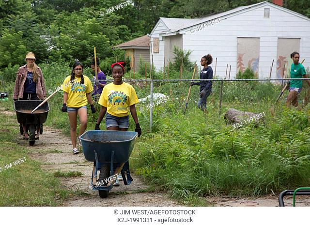 Detroit, Michigan - High school volunteers work in a community garden in Brightmoor, one of the most distressed neighborhoods of Detroit