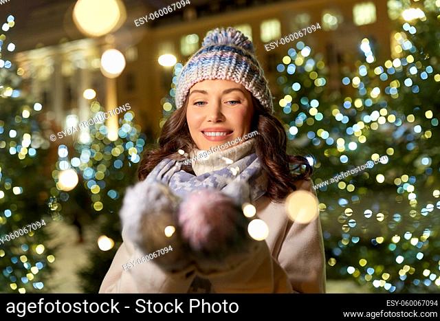 happy woman walking in christmas city in winter