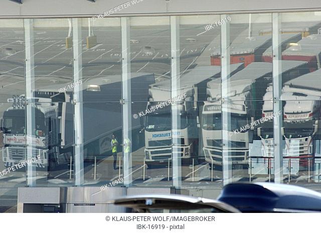 Lorries trucks reflectin in glass facade at the ferry port Dover Kent England
