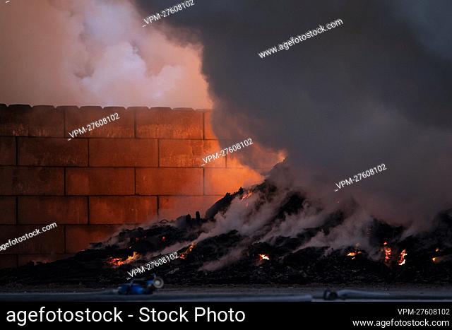Plumes of smoke pictured at the site of IOK recycling and waste management company, in Beerse, Monday 28 March 2022. BELGA PHOTO KRISTOF VAN ACCOM