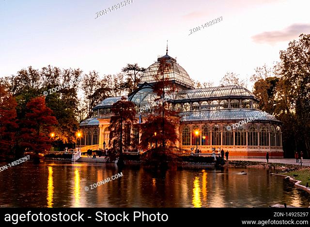 Madrid, Spain - November 10, 2019: The Glass Palace in Buen Retiro Park in Madrid. View at sunset in autumn time