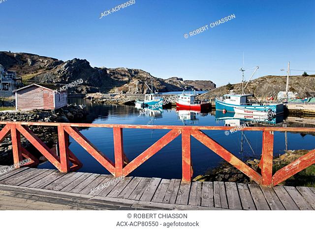Small harbour and three Cape Islander fishing boats as seen from a bridge on Middle Ridge Rd. in Brigus, Newfoundland, Canada