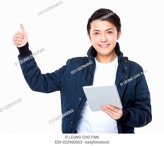 Man with tableta and thumb up