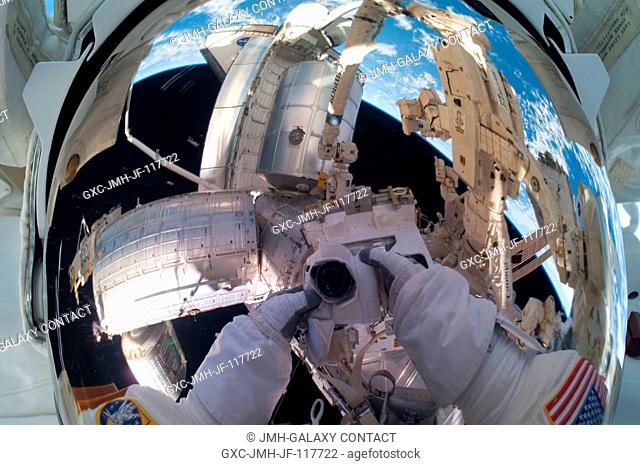 Because of his shiny helmet visor, this self portrait of NASA astronaut Mike Fossum, photographed during a July 12 spacewalk