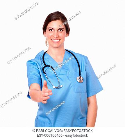 Portrait of a young lady nurse smiling with an ok hand gesture, on a isolated white background