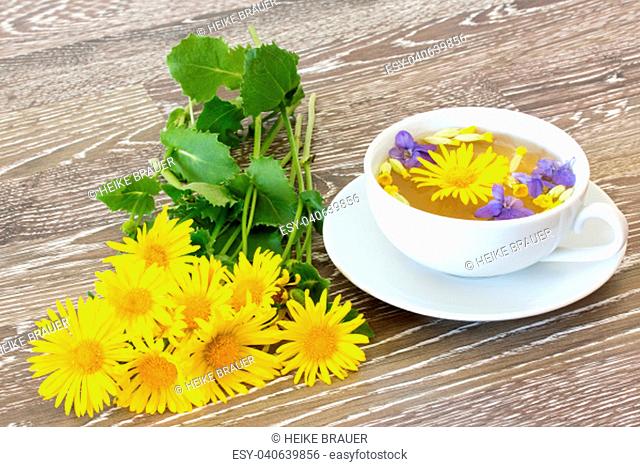 cup of herbal tea with coltsfoot