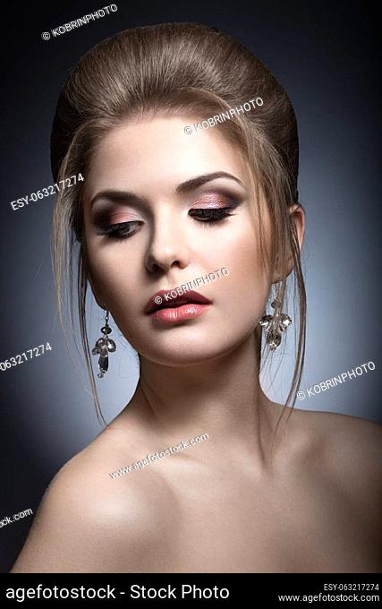 Portrait of a beautiful woman in the image of the bride with jewelry in her hair. Picture taken in the studio on a black background