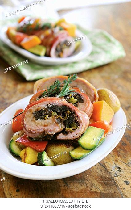 Rolled pork with date and citrus stuffing on roast vegetables