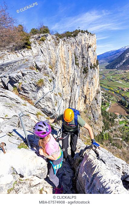 Family of climbers on the via ferrata of Mount Colodri, Arco di Trento, Trento province, Trentino Alto Adige, Italy, Europe