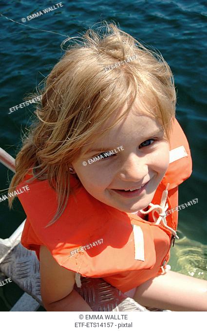 A girl wearing a life jacket