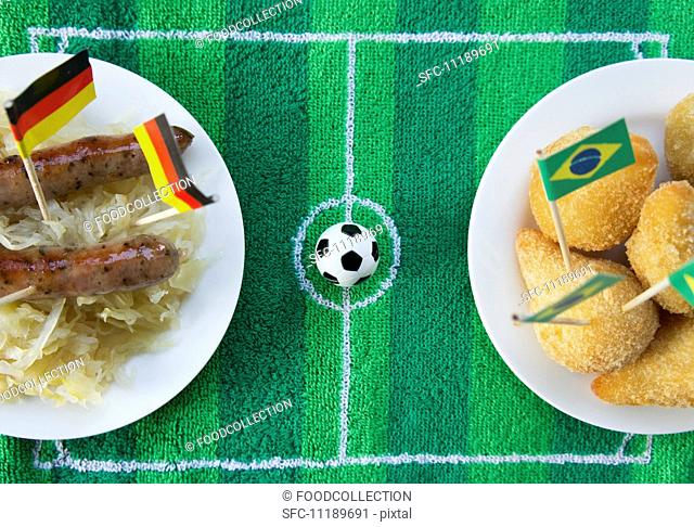 Sausages with cabbage (Germany) and salgadinhos (Brazil) with football-themed decoration