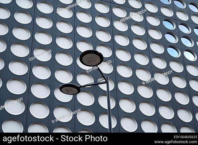 Utrecht, The Netherlands - July 12, 2023 - Patterns of a contemporary building with a street light