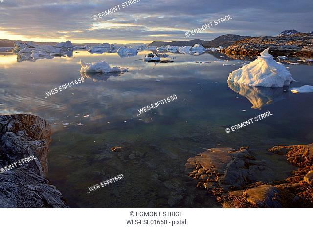 Greenland, East Greenland, view from Sarpaq over the icebergs of Sermilik fjord in the evening