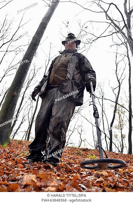 Karl-Ludwig Hohentann from Hofheim walks around a wooded hill with a metal detector near Riol,  Germany, 17 November 2015