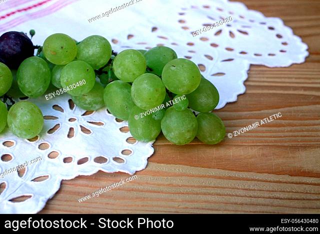 Grape cluster on a white tablecloth