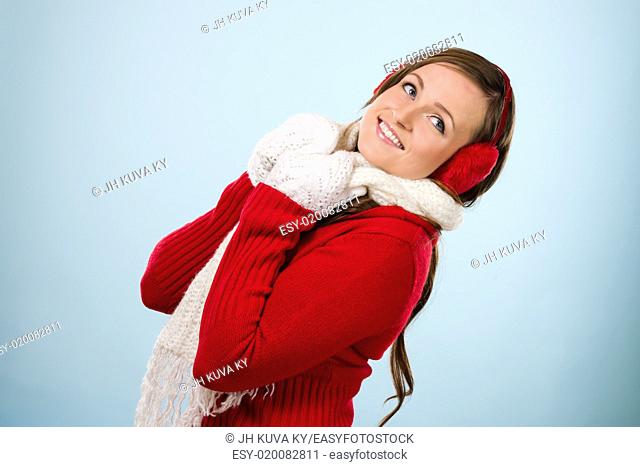 Beautiful young woman wearing a ear muffs and white scarf, horizon format