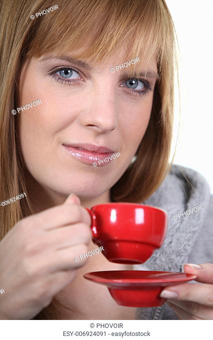 Ginger woman holding coffee mug