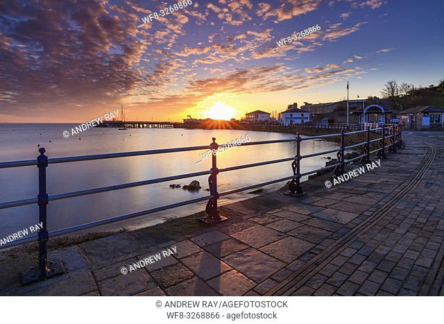 Sunrise captured from Swanage promenade on Dorset's Jurassic Coast, with the restored Victorian seaside pier in the distance