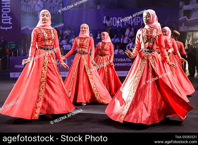 RUSSIA, GROZNY - MAY 25, 2023: Performers in traditional Chechen costume dance at the 1st international competitive programming festival, Kod Mira [World Code]