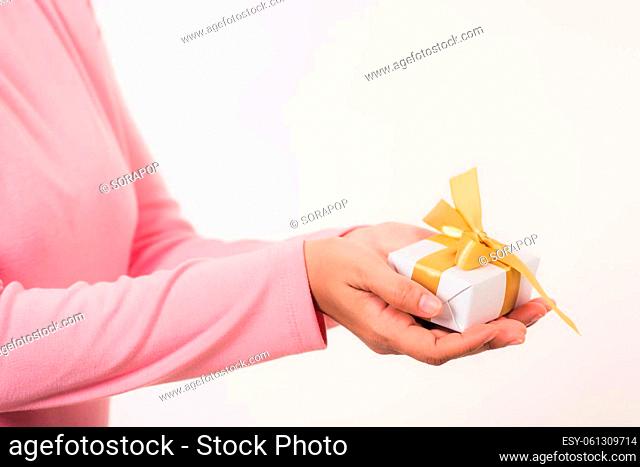 Valentine Day. Female beauty hands holding small gift package box present wrapped paper with ribbon isolated on white background, Christmas, New year