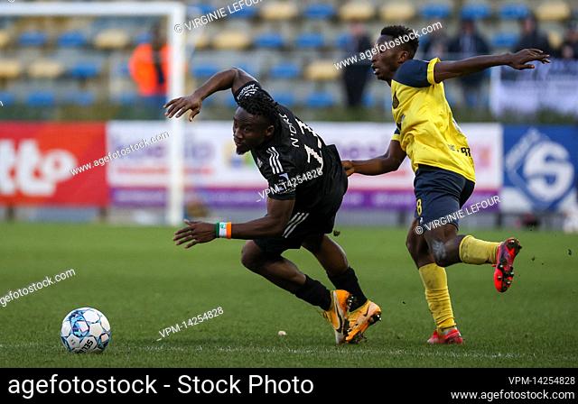 Eupen's Konan Ignace N'Dri and Union's Lazare Amani fight for the ball during a soccer match between Royale Union Saint-Gilloise and KAS Eupen