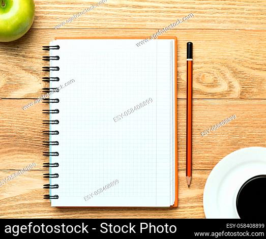 White blank paper with cup of coffee on wooden table