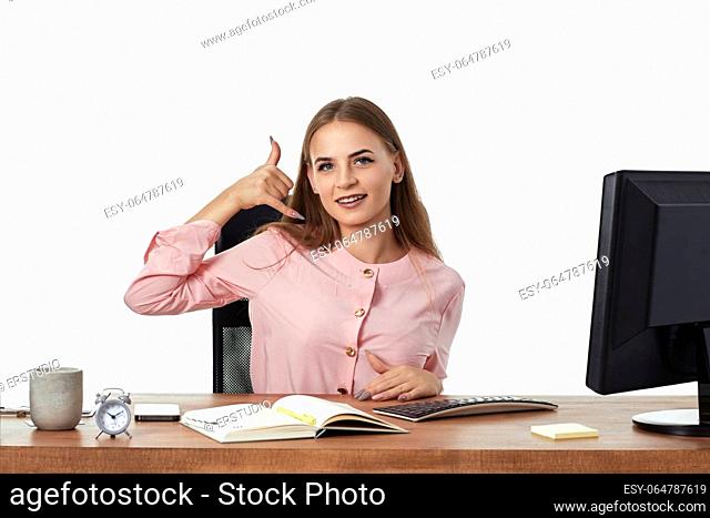 attractive woman using PC computer and doing talking on the telephone gesture. Call me back