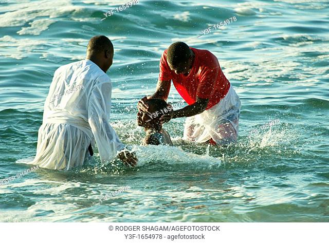 A baptism takes place early one morning in a coastal tidal pool  Cape Town, South Africa