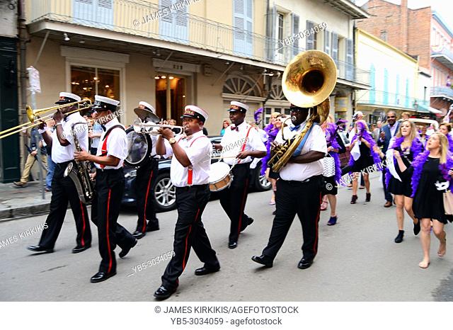 A Second Line leads a procession through the French Quarter of New Orleans