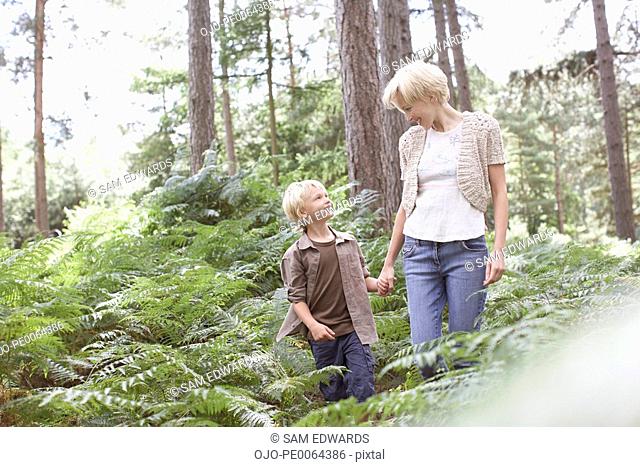 Mother and son walking in woods