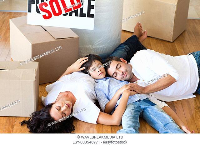 happy family moving house sleeping on floor