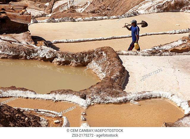 Worker in the salt flats on terraces at Salinas in the village of Maras, Salinas, Cuzco, Peru, South America