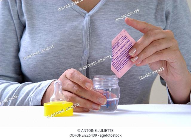 Woman feed bottle medicine