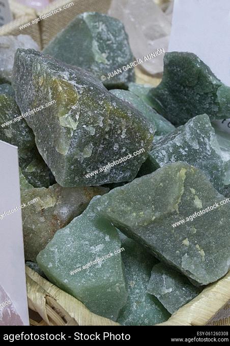 Green quartz fragments, believed to have beneficial health properties. Displayed on basket at street market stall