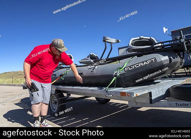 Evanston, Wyoming - An employee of the Wyoming Game & Fish Department inspects watercraft at a mandatory inspection station along the Utah border