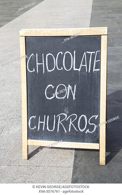 Chocolate and Churros Sign in Street, Spain