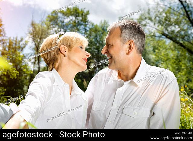 Senior couple sitting on beautiful spring day in love