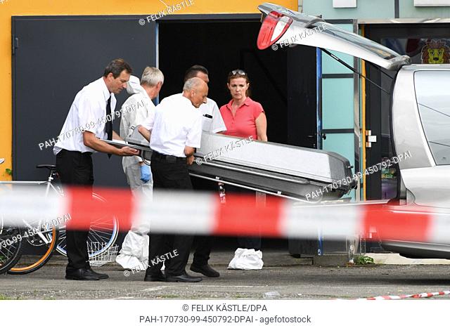 Undertakers carry a coffin out of the side entrance of Club Grey in Konstanz, Germany, 30 July 2017. A 34-year-old man committed a shooting in a disco - one...